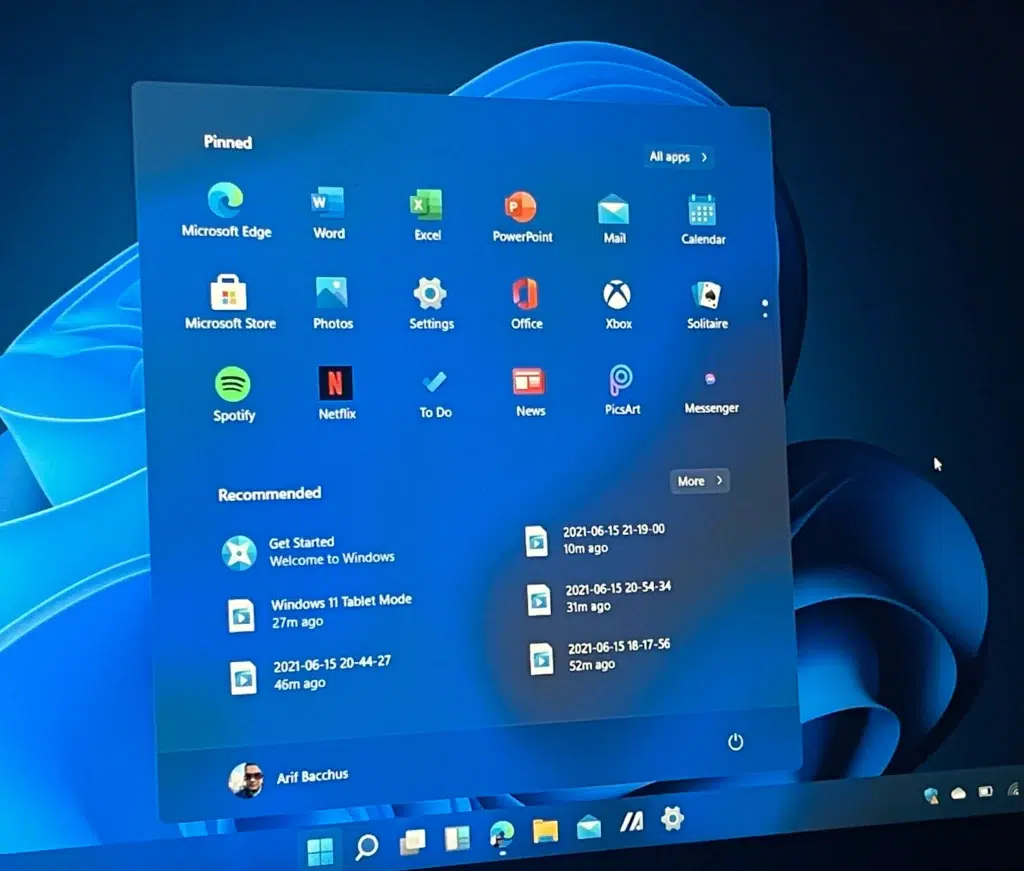 Windows 11 desktop interface showcasing pinned apps like Microsoft Edge, Word, Excel, and Spotify.